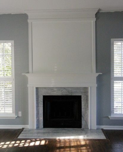 We used molding to extend our standard fireplace to the ceiling. Before, it was simple and standard. We just used a few pieces of molding and wood as well as white trim paint to give it a dramatic look. Before & After We painted everywhere except over the fireplace. We used a nail gun to add molding to form our fireplace shape. We added thick boards at the top to mimic the existing mantle. Here's how it all looked! We caulked all of the seams. We painted the entire a… Fireplace Renovation, Painting Trim White, Diy Fireplace Makeover, Fireplace Update, Wooden Fireplace, Brick Fireplace Makeover, Old Fireplace, Fireplace Hearth, Fireplace Remodel