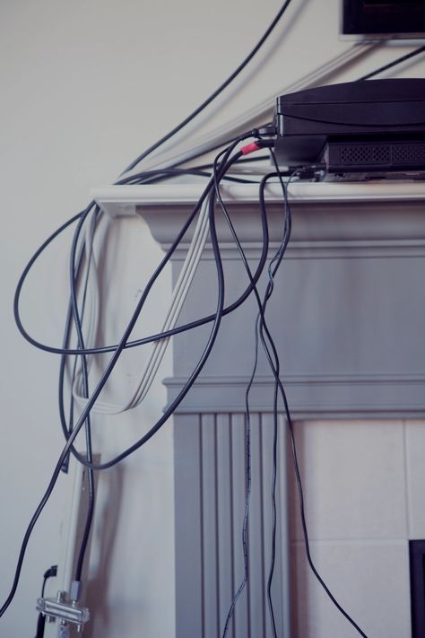 I'm an interior designer - and my simple trick will help you hide all those pesky cables without spending tons of money | The Sun Hiding Wires Mounted Tv, Diy Hide Tv Cords, Hide Cables On Wall, Hide Wires On Wall, Hiding Tv Cords On Wall, Hide Cords On Wall, Hide Tv Cable, Tv Cord Cover, Hide Tv Cords