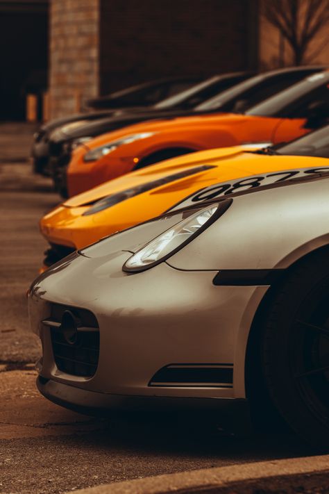 Line up at a car meet in downtown Indianapolis. A grey Porche, then a yellow and orange car, with two black cars in the background. Car Style Photography, Sport Car Photography, Cars Lined Up, Two Cars Photography, Classic Car Pictures, Sport Car Photoshoot, Car Photography Composition, Cool Car Photoshoot, Professional Car Photography