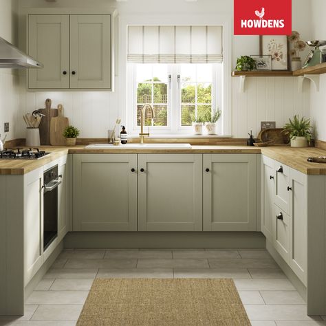 Introducing the stunning Howdens Halesworth Sage Green Kitchen. Perfect for traditional kitchen designs, these shaker-style green kitchen cabinets add a touch of elegance to any space. Pair them with oak kitchen countertops for a cohesive look that's both timeless and practical. The U-shaped kitchen design offers ample storage and workspace, making it perfect for busy families and home chefs. Trust us, this kitchen is a stylish and functional choice that you won't regret. Kitchen Floor With Green Cabinets, Two Tone Sage Kitchen Cabinets, Light Sage Kitchen, Light Sage Kitchen Cabinets, Green Kitchen Cupboards, Sage Green Kitchen Cabinets, Green Shaker Kitchen, Open Shelving Kitchen, Light Green Kitchen