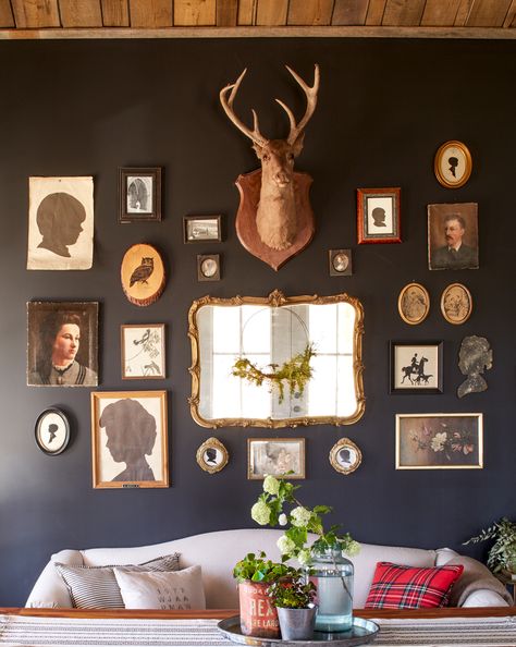 This cabin that mixes eras and textures is rustic, resilient and fits the family just right. Here, matte gray-black paint provides a sophisticated backdrop for a casual mix of framed and unframed family silhouettes, oil paintings, and a 1920s deer mount. Drop Cloth Slipcover, Deer Head Decor, Tennessee Cabins, Different House Styles, Rustic Cabin Decor, Dark Walls, Classic Decor, Deer Head, Spare Room