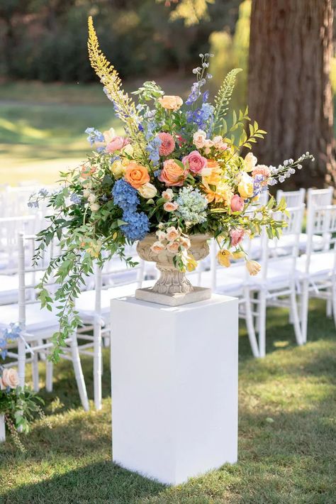 Colorful Aisle Flower Arrangement with Vase on Pedestal Pedestal Flower Arrangements, Diy Pedestal, Flower Urn, Colorful Wedding Flowers, Large Flower Arrangements, Aisle Flowers, Bright Wedding, Wedding Ceremony Flowers, Wedding Vases