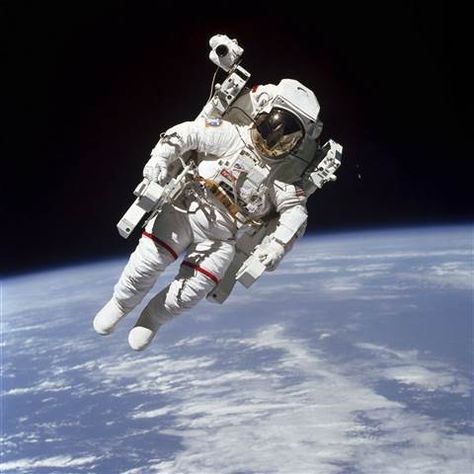 Image: This Feb. 7, 1984 photo made available by NASA shows astronaut Bruce McCandless II, participating in a spacewalk a few meters away from the cabin of the Earth-orbiting space shuttle Challenger, using a nitrogen-propelled Manned Maneuvering Unit. Background Stars, Space Shuttle Challenger, Nasa Missions, Sky Stars, Nasa Astronauts, Space Photos, Apollo 11, Astronauts In Space, Space Pictures