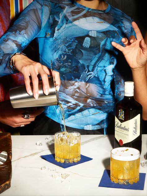 An image showing someone mixing up and pouring a Ballantine's Finest Whisky Sour at a house party