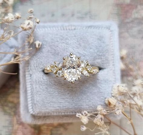 Wedding Ring With Accents, Engagement Rings With Clusters, Floral Oval Engagement Ring, Unique Engagement Rings Diamond Classy, Floral Band Engagement Ring, Cute Engagement Rings Unique, Vintage Floral Engagement Ring, 2024 Wedding Rings, Fairytale Engagement Ring Vintage