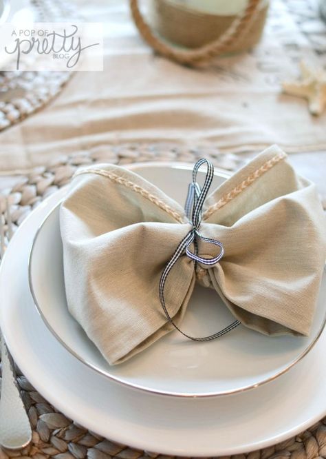 how to tie napkins into bows Tying Napkins With Ribbon, Napkin Ribbon Tie, Napkin Folding Ideas With Ribbon, Ribbon Tied Napkins, How To Tie Napkins Place Settings, Napkins Tied With Ribbon, Napkin Tied With Ribbon, Napkins With Ribbon, Napkin With Ribbon