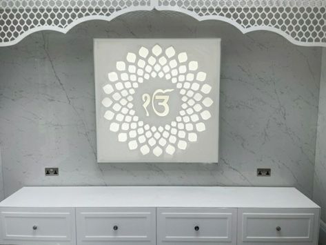 Ek Onkar symbol illuminated for prayer room. Designed for new home in UK. White corian and perspex Puja Room Design Indian Modern, Ek Onkar Symbol, Puja Room Design Indian, Onkar Symbol, Modern Partition, Nanak Jayanti, Modern Partition Walls, Ek Onkar, Divine Art