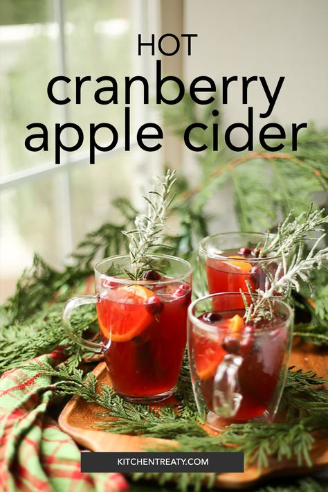 Three mugs of cranberry apple cider on foliage with the words "hot cranberry apple cider, kitchentreaty.com" Hot Spiced Cider Crock Pot, Hot Cranberry Apple Cider Recipe, Hot Mulled Cider Recipe Crock Pot, Mulled Pear Cider, Hot Apple Cider Recipe Alcohol, Christmas Cider Recipes Crock Pot, Hot Apple Cider Recipe Stovetop, Apple Cider Cranberry Drink, Apple Cider Christmas Drink