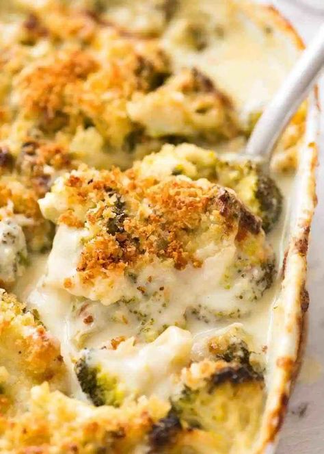 Close up of a spoon scooping up a serving of creamy garlic parmesan Broccoli Casserole