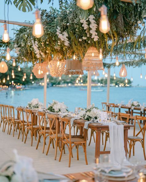 Stunning wedding dinner setup by the beach in Koh Samui, featuring elegant decorations that perfectly complement the serene seaside backdrop. Photography @andrewnguyen.atelier @hipsterwedding.asia Wedding planner @theweddingblissthailand Decor @iamflower.co Venue @salachawengbeach #beachweddingdecor #beachweddingideas #weddingreceptiondecor #weddingreceptionideas #weddingreceptions #weddingreceptioninspiration #beachweddings #beachweddinginspiration #kohsamuiwedding #kohsamuiweddingphotog... Beach Wedding Reception Ideas Decor, Upscale Beach Wedding, Beach House Wedding Decor, Earthy Beach Wedding, Beach Wedding Dinner Table, Beach Boho Wedding Decor, Green Beach Wedding Theme, Wedding Inspiration Beach, Wedding Venue Ideas Outdoor Beach