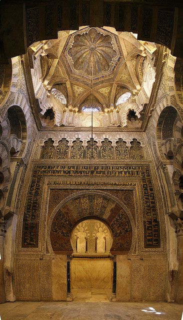 The Great Mosque, Cordoba, Spain: Mihrab. The focal point in the prayer hall is the famous horseshoe arched mihrab or prayer niche. A mihrab is used in a mosque to identify the wall that faces Mecca—the birth place of Islam in what is now Saudi Arabia—which Muslims face toward during their daily prayers. The mihrab in the Great Mosque of Cordoba is framed by an exquisitely decorated arch behind which is an unusually large space, the size of a small room. Above is a dazzling gold mosaic dome. Islamic Spain, Great Mosque Of Córdoba, Inspiring Architecture, Cordoba Spain, Al Andalus, Mosque Architecture, Beautiful Mosques, Architectural Photography, Sacred Places