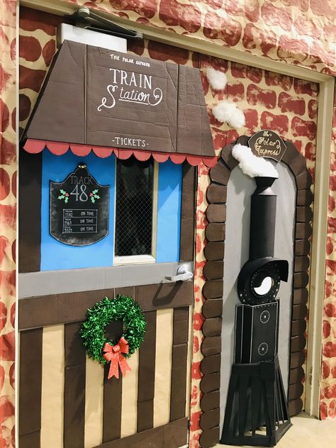 Christmas door decoration Christmas Village Door Decorating Contest, Diy Train Station Ticket Booth, Polar Express Ticket Booth Door, Train Station Classroom Theme, Christmas Village School Hallway, Christmas Village Classroom Door, Christmas Work Cubicle Decor, Polar Express Decorations Hallways, Santas Workshop Door Decoration