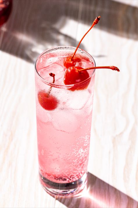 Overhead view of a pink cocktail in a tall glass with ice. Three maraschino cherries are on top. Valentine S Day Cocktails, Pink Celebration, Cute Vodka Cocktails, Valentine Cocktails Easy, Galentines Party Cocktails, Galentines Valentines, Drinks Valentines Day, Cherry Sweets, Red And Pink Food