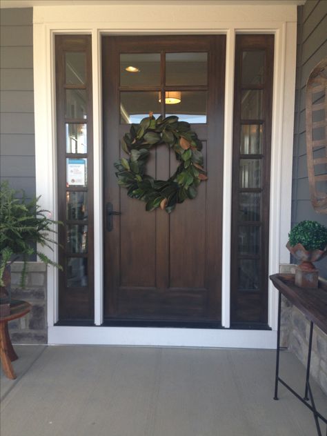 Front door on the farmhouse with magnolia wreath Country Farmhouse Front Door, 3 Piece Front Door, Shop House Front Doors, Dark Wood Front Door With Sidelights, Stain Front Door Wood, Front Doors With Top Window, Industrial Farmhouse Front Door, Gray House Brown Front Door, Dark Stained Front Door