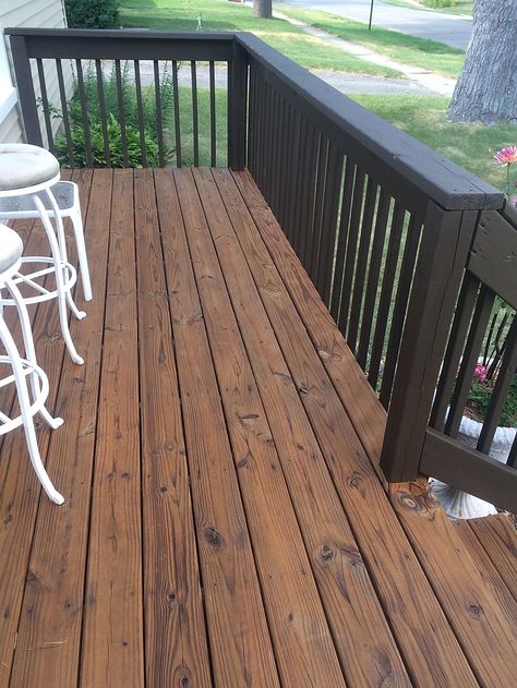 Dark Porch Stain, Wood Front Porch Makeover, Dark Stained Deck With Black Railings, Black Wood Deck Railing, Brown Deck With Black Railings, Brown House Deck Color, Dark Porch Ideas, Brown And Black Deck Ideas, Deck Colors Ideas Paint Brick House