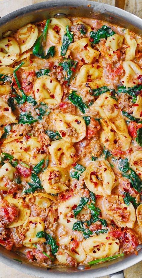 Creamy Tortellini with Sausage, Spinach, Tomatoes, and Mozzarella in a stainless steel skillet Tortellini With Sausage, Tortellini With Spinach, Creamy Sausage Tortellini, Mozzarella Cheese Sauce, Spinach And Tomato Tortellini, Tomatoes And Mozzarella, Creamy Tortellini, Sausage Spinach, Spinach Tortellini