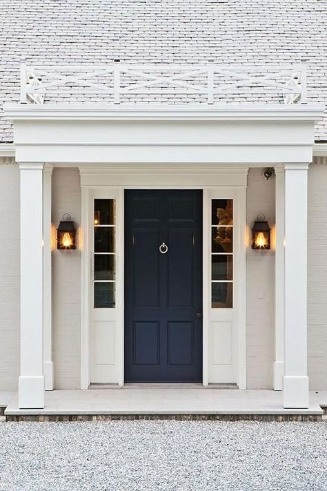 Beautiful home exterior boasts a navy front door flanked by sidelights illuminated by carriage lantern wall sconces. Transitional Home Exterior, Navy Front Door, Blue Front Door, Revere Pewter, Casas Coloniales, Have Inspiration, Front Entry Doors, Front Door Colors, Transitional House