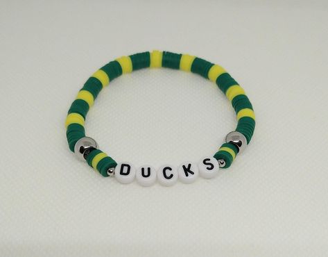 Duck Friendship Bracelet, Nfl Clay Bead Bracelets, Football Beaded Bracelets, Florida Gators Beaded Bracelet, Duck Bracelet, Football Jewelry, Ducks Football, Football Bracelet, Yellow Bracelet