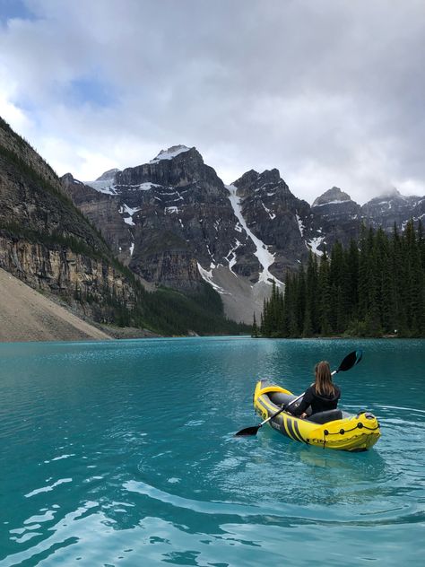 Yellow kayak in bright blue water with a beautiful snow topped mountain background Canada Lakes Aesthetic, Louise Lake Canada, Canada Lake Louise, Banff Kayaking, Canada Moodboard, Places To Go In Canada, Banff Trip, Magical Lake, Canada Lake