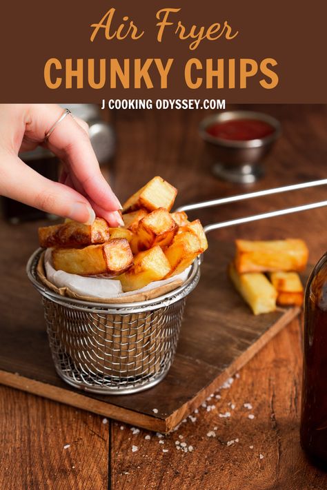 A female hand is picking air fryer chunky chips or fries English Chips Recipe, Chips In Air Fryer How To Make, English Chips, Potato Chips Homemade Airfryer, Home Made Chips Air Fryer, Noodle Chips In Air Fryer, Air Fryer Floppy Chips, Homemade Fish And Chips Air Fryer, Air Fryer Recipes Chips