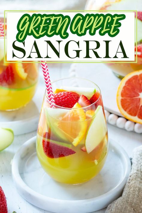 Looking for a refreshing fruity cocktail? Try this easy green apple sangria recipe! Crisp green apples, sweet white wine, and zesty lemon, make this the pitcher-perfect addition for pool parties, porch sippin,’ or girls night in. Green Apple Sangria Olive Garden, Olive Garden Apple Sangria Recipe, Olive Garden Sangria, Olive Garden Sangria Recipe, Green Apple Sangria, Green Apple Moscato Sangria, Moscato Sangria Recipes, Apple Sangria Recipes, Moscato Sangria