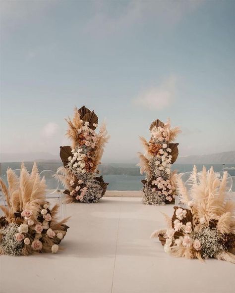 Let the natural colors and textures weave their magic as you say your vows surrounded by gorgeous boho installations like these! | wedding planning, outdoor wedding decor, outside wedding decor, wedding aisle decor, wedding ceremony decor, boho wedding, bohemian wedding decor, wedding flowers, wedding floral designs, boho floral arrangements, boho wedding inspo, summer wedding, summer wedding decor, outdoor wedding ceremony, boho floral designs, bohemian bride #summerwedding #weddingceremony Boho Modern Wedding, Bohemian Wedding Ceremony, Ceremony Altar, Bohemian Wedding Theme, Modern Wedding Ceremony, Summer Wedding Decorations, Boho Beach Wedding, Ethereal Wedding, Santorini Wedding