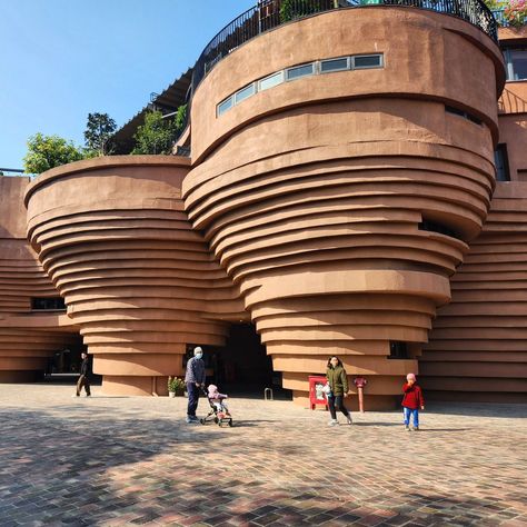 An architectural studio designed the four-story Bat Trang Pottery Museum as a way to pay homage to the traditions of the village that go back to the 11th century. The shape of the building is inspired by the shape of pots created on a potter's wheel and the terracotta colour references the earthen material and bricks used to build kilns. I spent a lovely day exploring this village which began first with a stop at this museum, which luckily also had some ongoing exhibitions, where local artisa... Pottery Architecture, Pottery Exhibition, Pottery Museum, Terracotta Colour, Architecture Design Presentation, Architectural Studio, Traditional Pottery, Architecture Collage, Design Presentation