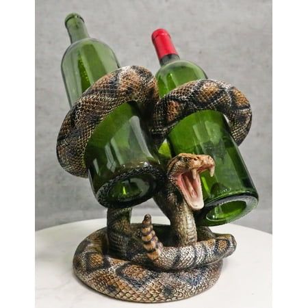 This Rattlesnake Double Wine Bottles Holder measures 8.5" tall, 9.25" long and 7" deep approximately. It weighs about 4.5 pounds.  This Rattlesnake Double Wine Bottles Holder is made of designer composite resin, hand painted and polished individually. Color Tone May Vary from pictures.  This realistic rattlesnake double wine bottles holder is beautifully hand painted. It has the perfect look for any bar in your house or mancave.  Props and wine bottles in photos are not included with the item. S Ceramic Snake, Animal Skull Decor, Diamondback Rattlesnake, Cowboys Bar, Ranch Ideas, Wine Holder, Wine Bottle Holders, Wine Racks, Animal Skulls