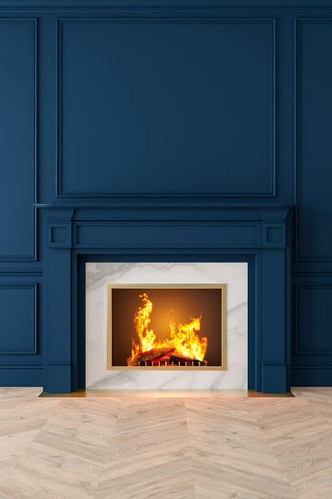 Give your fireplace the dramatic backdrop it deserves with an accent wall that stands out. This article will reveal nine eye-catching colors that are perfect for adding an extra touch of elegance and excitement to your room. Royal Blue Fireplace, Wainscoting Ideas Around Fireplace, Box Molding Fireplace, Navy Fireplace Surround, Chimney Accent Wall, Batten Board Fireplace Wall, Blue Accent Wall Living Room Fireplace, Painted Fireplace Wall Ideas, Accent Wall And Ceiling Same Color