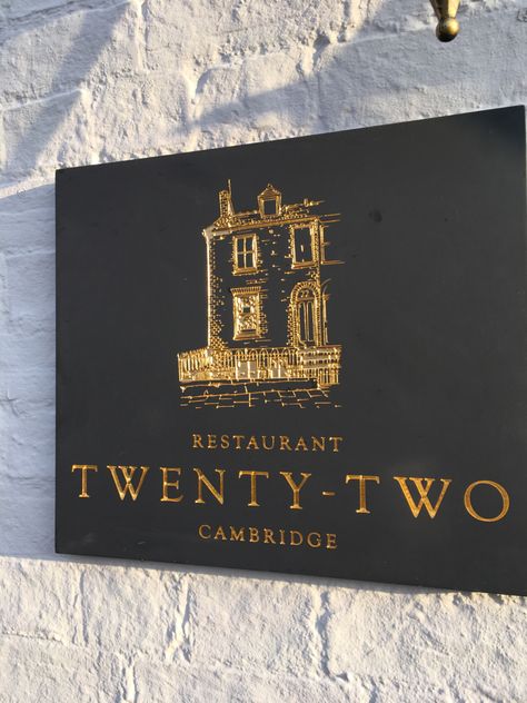 Finest quality Welsh Slate signage, created for Restaurant Twenty-Two in Cambridge, England. Featuring gilded, engraved lettering and etched gilded logo design. Get in touch at hello@stonesign.com to create your bespoke business sign. Luxury Signage, Luxury Signage Design, Luxury Restaurant Branding, Stone Signage, Gold Leaf Signage, Brass Signage, Gold Foil Window Signage, Gold Signage, Brass Letters Signage