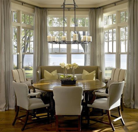 Gorgeous round dining table in front of a bay window with an amazing water view! Wonderful design by Hickman and Associates - round dining tables - monochromatic color scheme - casual dining room Bay Window Decorating Ideas, Bay Window Dining, Dining Room Bay Window, Kitchen Bay Window, Breakfast Nook Table, Nook Table, Breakfast Rooms, Casual Dining Rooms, Breakfast Nooks