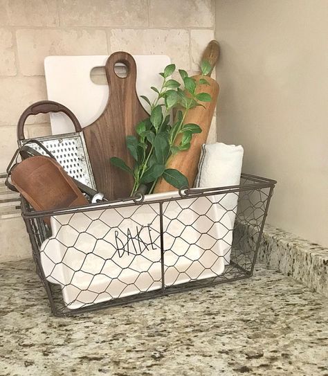 No photo description available. Tray Basket Decor, Wire Basket Decor Kitchen Farmhouse, Decorating With Wire Baskets Display, Chicken Wire Basket Decor Ideas, Wire Basket Decor Kitchen, Basket Decor Kitchen, Decorating With Wire Baskets, Metal Basket Decor Ideas, Wire Basket Decor Ideas