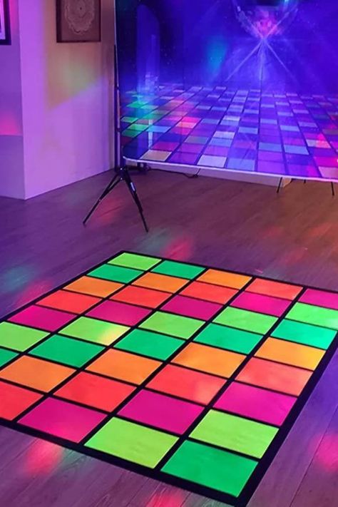 A neon party is a great excuse to throw a dazzling disco with great music and bright colors. Blacklights were really popular in the '70s, so how about throwing a '70s-themed disco with a retro music playlist? This florescent-colored dance floor is just what you need at your party to add to the disco vibe! See more party ideas and share yours at CatchMyParty.com 70s Disco Party Table Decorations, Diy Disco Dance Floor, Edm Birthday Party Ideas, Neon Preppy Party, 90s Glow Party, Diy Neon Decorations, Neon Graduation Party, Neon 40th Birthday Party, Glow In The Dark Party Decor