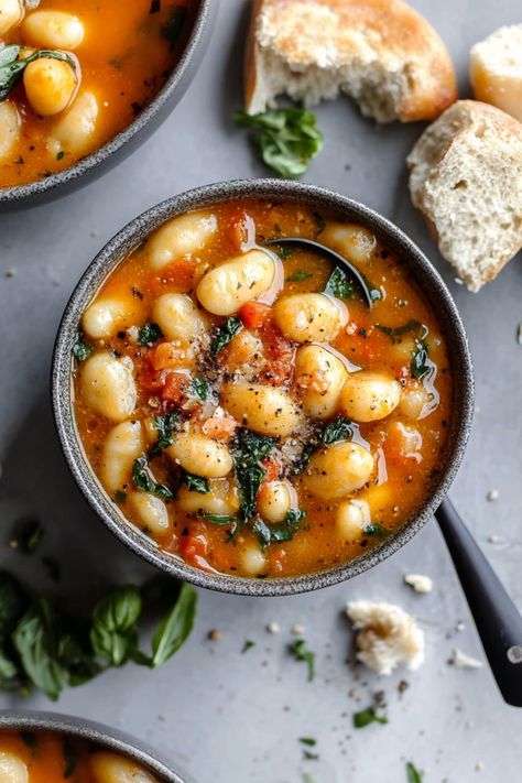 Discover the ultimate comfort food with our Creamy Tuscan Vegan Gnocchi Soup! This rich and hearty dish features pillowy gnocchi, tender kale, and a creamy garlic-infused broth that's completely dairy-free. Perfect for a cozy night in or a healthy weeknight dinner, this vegan soup will satisfy your cravings without the guilt. Vegetarian Tuscan Soup, Cozy Vegetarian Soups, Vegan Gnocchi Soup Recipes, Meatless Gnocchi Soup, Vegan Italian Penicillin Soup, Dairy Free Gnocchi Soup, Tuscan Gnocchi Soup, Gnocchi Soup Dairy Free, Vegan Gnocchi Dishes