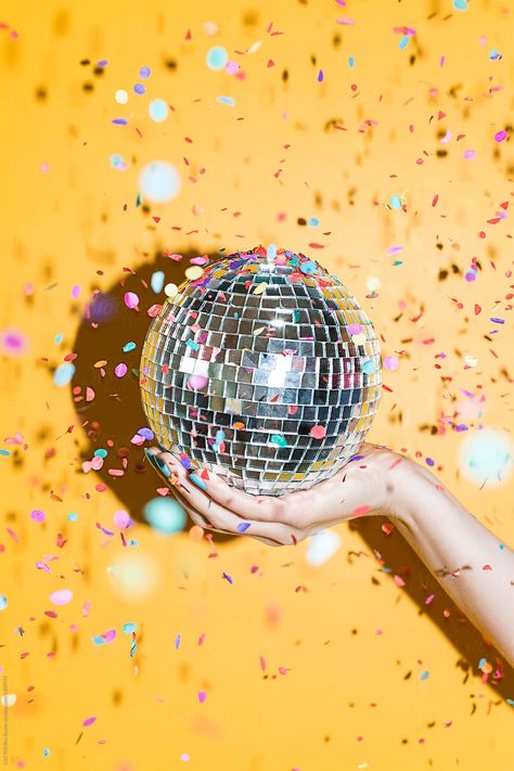 Hand holding a disco mirrors ball with confetti in a party Disco Mirror, Confetti Sprinkles, Mirror Ball, Hand Holding, Disco Ball, Confetti, Sprinkles, Cactus, Mirror