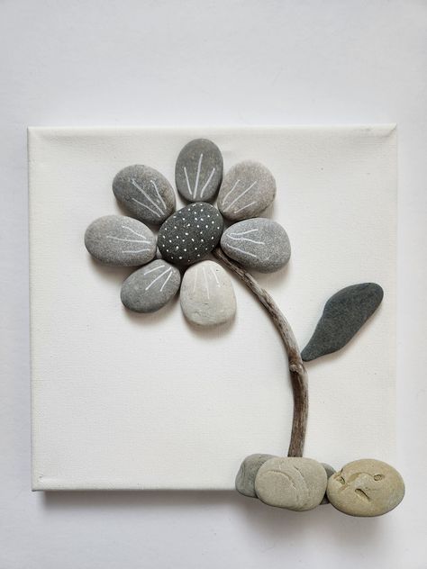 These dainty little black, gray, and white flowers will bring happiness to any room! Lakeshore Rock Art handpicks each rock from the shores of Lake Michigan.  And since no two rocks are the same, we can GUARANTEE that your Rock Art is 100% UNIQUE!  Because of this uniqueness, your final product will look slightly different than the photo above. We do our best to make it as close as possible to the original. Have an idea you would like to see transformed into Rock Art?  Send us a message and we w River Rock Art Pebble Mosaic, Rock Stacking Art, Flower Pebble Art Ideas, Shadow Box Rock Art, Stone Crafts Diy Rock Art, Diy Rock Decor, Rock Mosaic Art, Rock Crafts For Adults Diy Projects, Pebble Art Ideas Inspiration