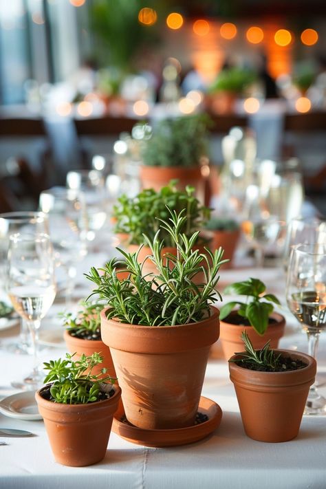 Bring a fresh twist to your wedding tables with our DIY guide on creating eco-friendly centerpieces! 🌿💐 Perfect for the green-hearted couple, these potted herbs add a natural scent and charm to your decor. Plus, guests can take home a piece of your special day. #EcoWedding #DIYCenterpiece #HerbGarden #SustainableLiving #WeddingIdeas #GreenWedding #WeddingDecor #EcoChic Restaurant Table Centerpiece Ideas, Plant Themed Wedding Wedding Table Decor, Wedding Decor Potted Plants, Potted Herbs Tablescape, Clay Pot Wedding Decor, Botanical Table Decor, Herbs As Centerpieces, Potted Herbs Centerpiece, Eco Friendly Centerpieces