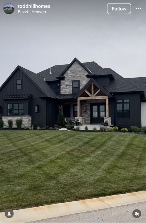 Black And Cedar House Exterior With Stone, Modern Dark Farmhouse Exterior, Black House Exterior Stone Accents, Dark House With Stone, Black House Black Trim, Black House With Brick Exterior, Dark Home Exterior Brick, White And Black House Exterior With Stone, Rural Home Exterior