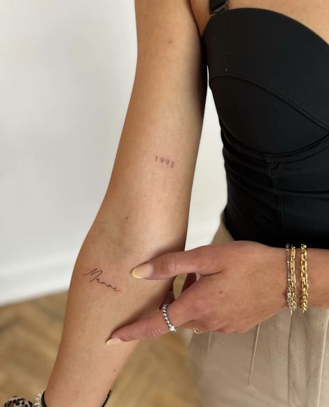 Year Tiny Tattoo, Date Tattoo Fine Line, Date Tattoo Above Elbow, Inner Arm Tiny Tattoo, Dainty Number Tattoo Placement, Minimalist Tattoo Placement For Women, Lots Of Love Tattoo, Fine Line Birth Year Tattoo, Tiny Birth Year Tattoo