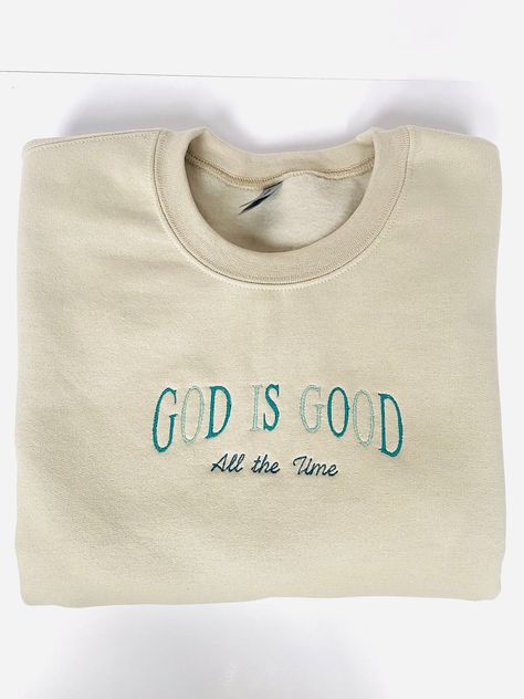 Get cozy in style with the "God is Good all the Time" Sweatshirt! This comfy long-sleeved sweater features Neutral toned colors showcasing the God is Good all the time design, making it the perfect gift for your friends, family, or yourself! So whether you're cozying up at home or stacking chairs at your local church, this sweatshirt has got your back. -Embroidered on a cotton/polyester blend crewneck sweatshirt, this design is simple and minimalistic, perfect for every outfit! -Embroidery design measures 5" x 7". -See product pictures for shirt sizing chart. -All sweatshirts are handmade on an embroidery machine so there may be slight differences, but we only sell the sweatshirts that meet our high-quality standards. -To maintain the quality of your sweatshirt and the embroidery design ma Christian Sweatshirt Designs, Christian Shirt Embroidery, Christian Embroidery Sweatshirt, Christian Apparel Embroidered, Christian Embroidery Designs, Christian Crew Neck Sweatshirt, Christian Apparel Sweatshirts & Hoodies, Jesus Clothes, Jesus Sweatshirts