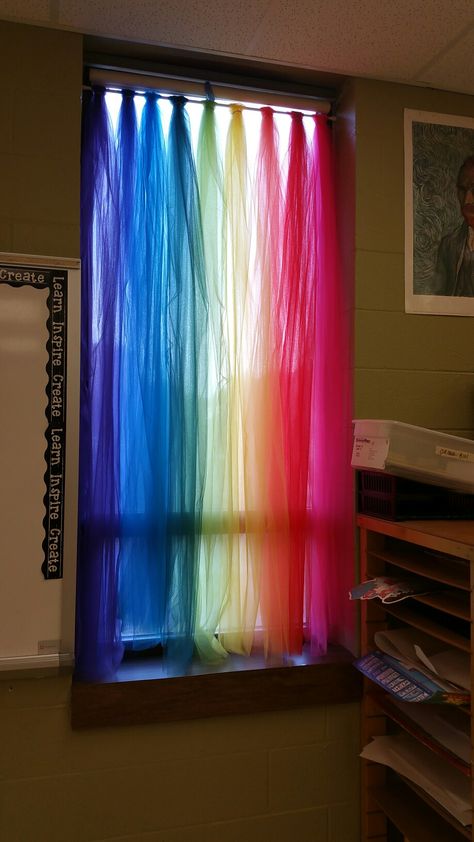 Closer up on my new art classroom curtains that I made with tulle, Merrill Elementary art room. IG: @rainbow.art.teacher Class Decoration Ideas Art Rooms, Rainbow Curtains Classroom, Rainbow Daycare Decor, Art Room Decorations, Rainbow Window Display, Rainbow Ideas Decorations, Art Themed Classroom, Diy Classroom Curtains, Classroom Curtain Ideas