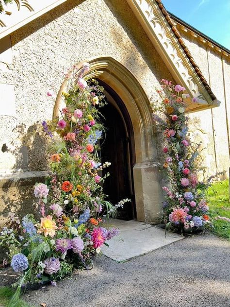 a large abundant floral archway at a church entrance created with colourful and elegant summer blooms Summer Wedding Floral, Wildflower Wedding Theme, Wedding Church Decor, Floral Archway, Church Wedding Flowers, Bright Wedding Flowers, Floral Arch Wedding, Pastel Wedding Flowers, Colorful Wedding Flowers