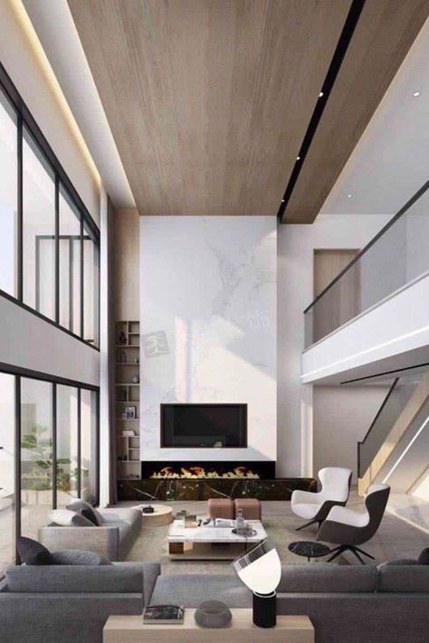 We're obsessed with this living room design. It has unique details and the perfect statement pieces! Find out the Best Interior Designers in New York City in the link below! #newyorkfurniture #newyorkart #newyorkarchitecture #newyorkproperty #newyorkdesigner Double Height Fireplace Modern, Wood Accent Wall High Ceiling, Double Volume Living, High Ceiling Tv Wall Interior Design, Tv Wall Double Height, Modern Fireplace High Ceiling, Double Height Living Room Fireplace, Double Height Ceiling Living Rooms, Double Volume Ceiling Design