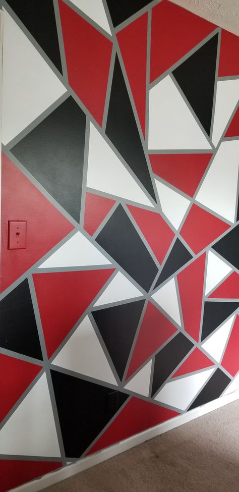 DIY geometric wall using red black and white paint on top of a gray base. Geometric Wall Paint Gray, Red Black White Gray Bedroom, Red Gray And Black Bedroom, Red Black And White House Decor, Red And Black Painted Walls Room Colors, White And Gray Accent Wall, Black And Red Walls Bedroom, Black And Red Accent Wall, Red Black Gray Bedroom