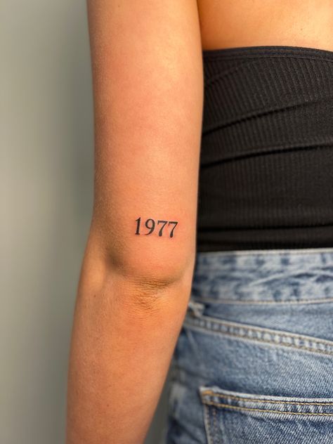 Tattoo Ideas Female Birth Year, 1975 Number Tattoo, Born Year Tattoo Ideas, Dates On Back Of Arm Tattoo, 2 Dates Tattoo, Small Year Tattoos, Year Tattoo On Wrist, Year Born Tattoo Ideas, 1965 Tattoo Number