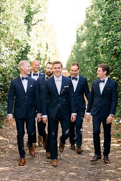 Royal Blue Groomsmen Suits Bridesmaid Dresses, Wedding Suits Men Blue Navy Brown Shoe, Taupe Dresses Blue Suits, Terra Cotta Dresses And Navy Suits, Groomens Attire Navy Blue Suits, Champagne Bridesmaid Dresses With Navy Blue Grooms, Navy Suit Terracotta Dress, Bridal Party With Navy Blue Suits, Blue Suits And Champagne Dresses