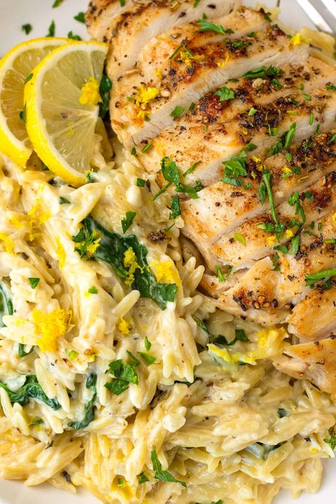 Lemon Chicken Orzo! This creamy one pot lemon chicken orzo is perfect for weeknights, and an amazing comfort food recipe. The orzo is tender, and it's tossed with fresh lemon and spinach. Lemon Orzo With Chicken, Greek Chicken And Lemon Rice One Pot, Lemon Chicken Orzo Bake Boursin, Lemon Chicken Orzo Crockpot Recipes, Lemon Chicken With Orzo Recipe, Orzo Chicken Thigh Recipes, Chicken Orzo Instant Pot Recipes, Greek Chicken Orzo Bake, Sides For Lemon Chicken