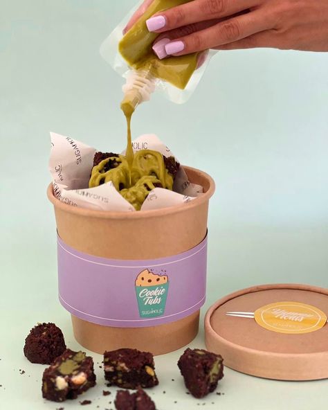 Chunky Choc Pistachio Cookie Tub Is NOW LIVE 💚 Indulge in our gourmet Chocolate Pistachio Chunky Cookies, baked with rich Belgian chocolate and real pistachios 🤩 Enjoy a delicious flavor explosion with every bite! Order your tub for delivery in 🇦🇪 #ShopNow : https://sugaholic.com/desserts/Chunky-Cookies/pistachiocookietub #Sugaholic #cookiesindubai #cookietubs #chunkycookies Cookies Bites, Chocolate Business, Brownies Cookies Packaging, Jumbo Cookie Packaging, Cookies Business Ideas, Thick Chunky Cookies, Chunky Cookies Chocolate Chips, Pistachio Chocolate Chunk Cookies, Bakery Packaging Design