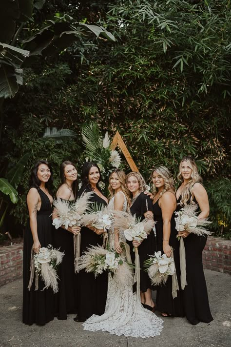 Tropical Industrial Millwick Wedding | Junebug Weddings Dark Boho Bridesmaid Dress, Boho Wedding Black Bridesmaid Dresses, Pampas Grass Wedding Black, Spring Wedding With Black Bridesmaid Dresses, Black Bridesmaid Dresses Tropical Wedding, Black Wedding With Pampas, Wedding Colors With Black Bridesmaid Dresses, Black White Pampas Wedding, All Black Boho Wedding