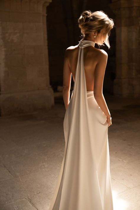 Introducing our exquisite sheath wedding dress, a vision of modern elegance and timeless allure. Crafted from luxurious glossy satin, this dress is designed to accentuate your every curve and create a sleek silhouette. The deep V-neckline with a halter-style neckline adds a touch of sensuality, beautifully framing your décolletage. The daring backless design is a captivating detail that will leave everyone in awe as you make your grand entrance. But it doesn't end there - the true showstopper of High Neck Low Back Wedding Dress, Vintage Italian Wedding, Italian Wedding Dresses, Bohemian Style Wedding Dresses, Robes Glamour, Ivory Lace Wedding Dress, Gcse Science, Hollywood Dress, Dream Wedding Ideas Dresses